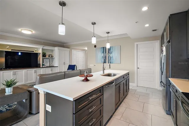a kitchen with a sink stainless steel appliances and cabinets