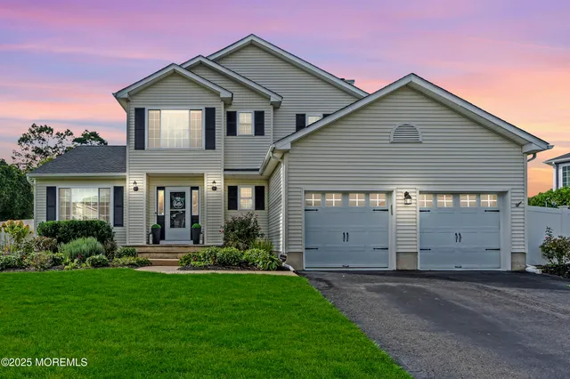a front view of house with a garden