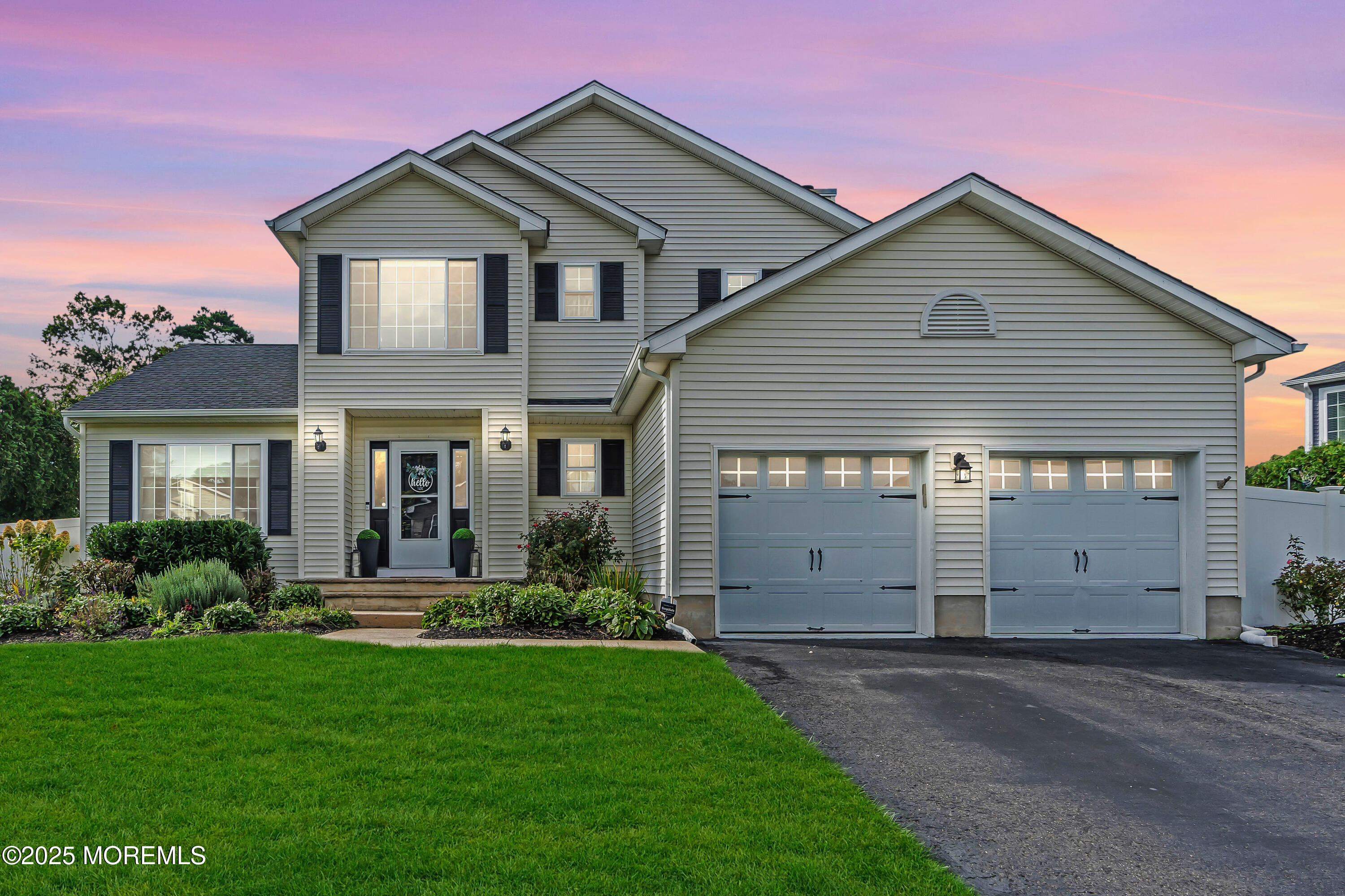 a front view of house with a garden