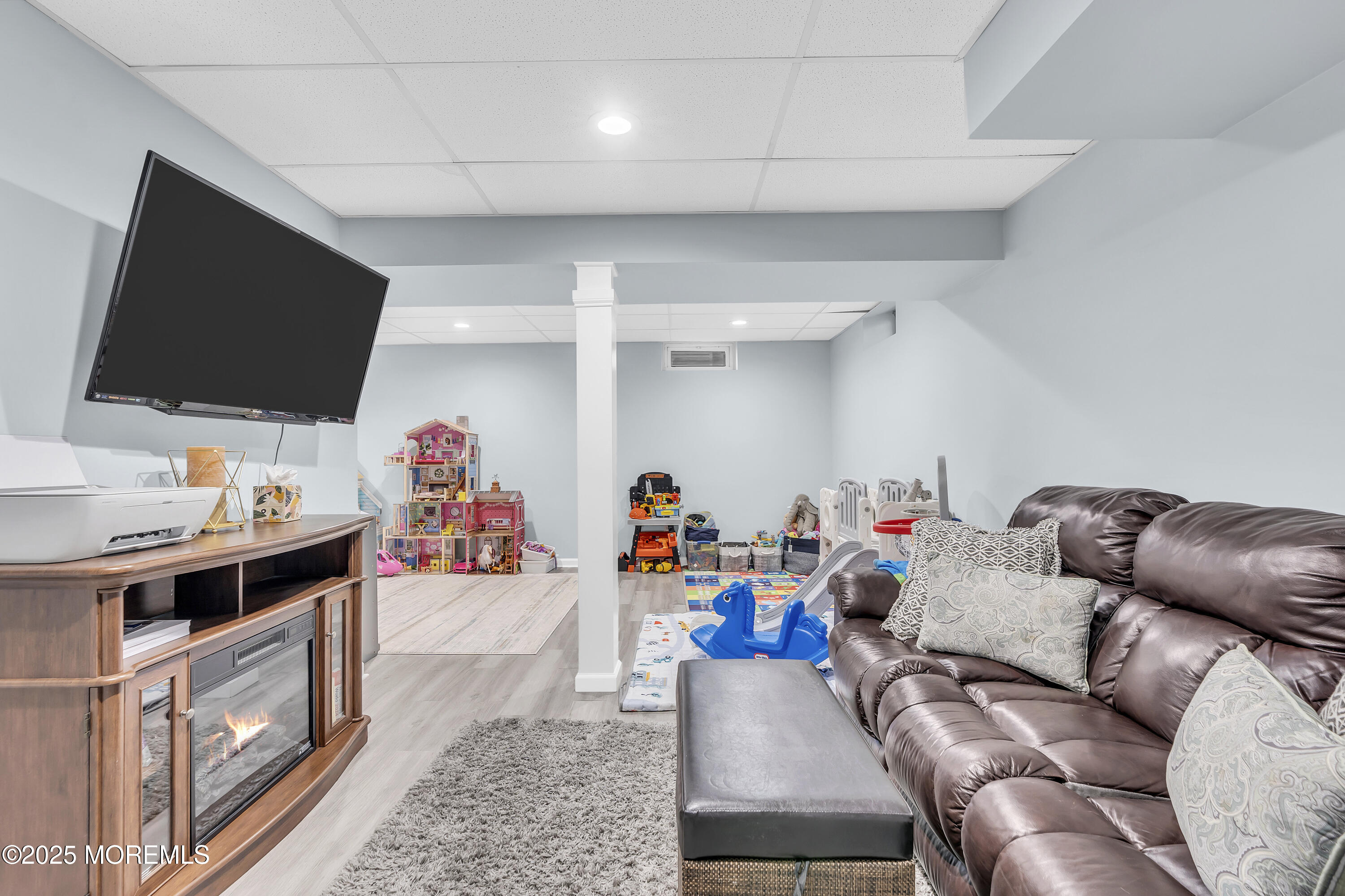 4 Rainbow Drive Howell, NJ 07731 - Photo 23 of 38 a living room with furniture and a flat screen tv
