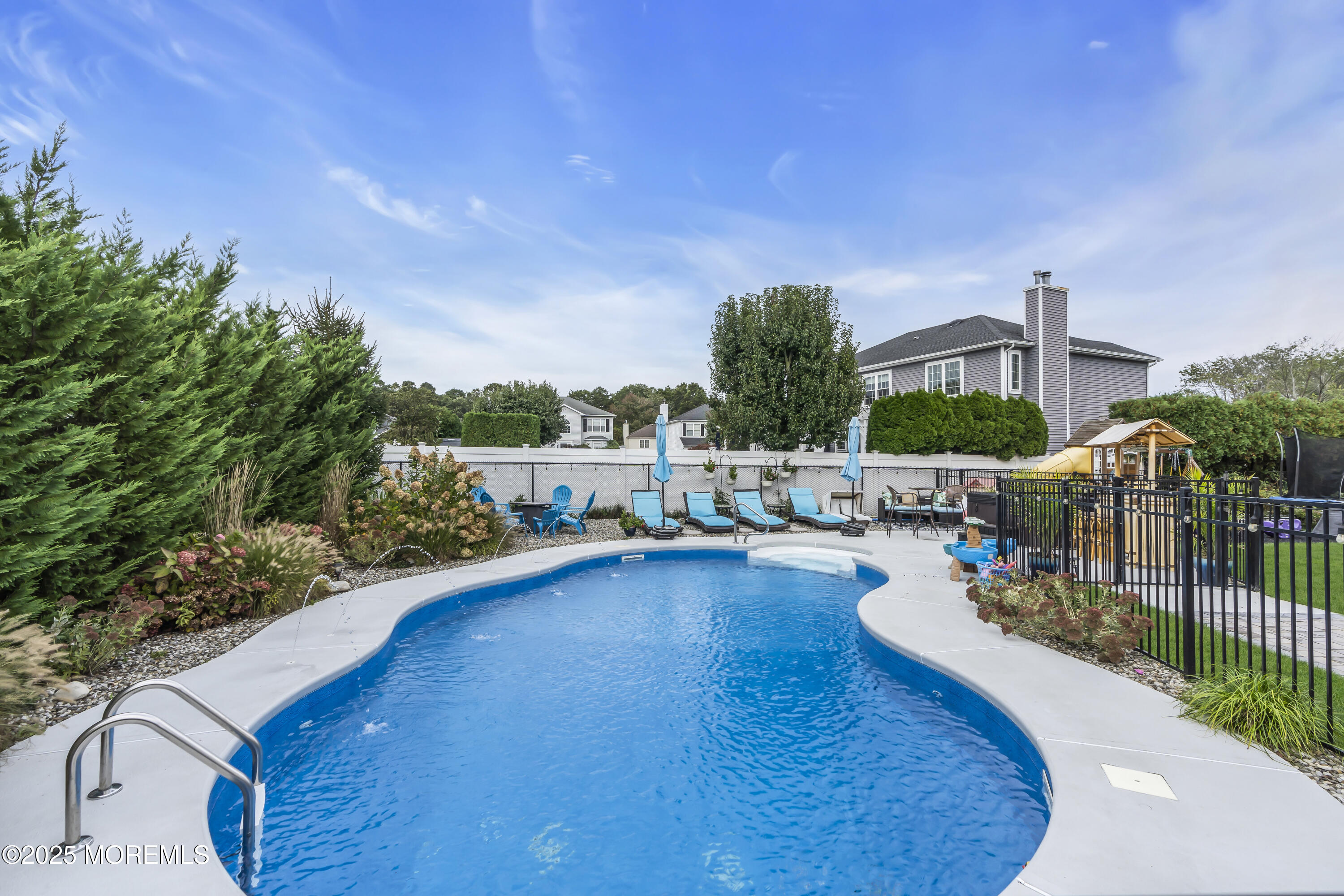 4 Rainbow Drive Howell, NJ 07731 - Photo 26 of 38 a view of a swimming pool with a patio and garden