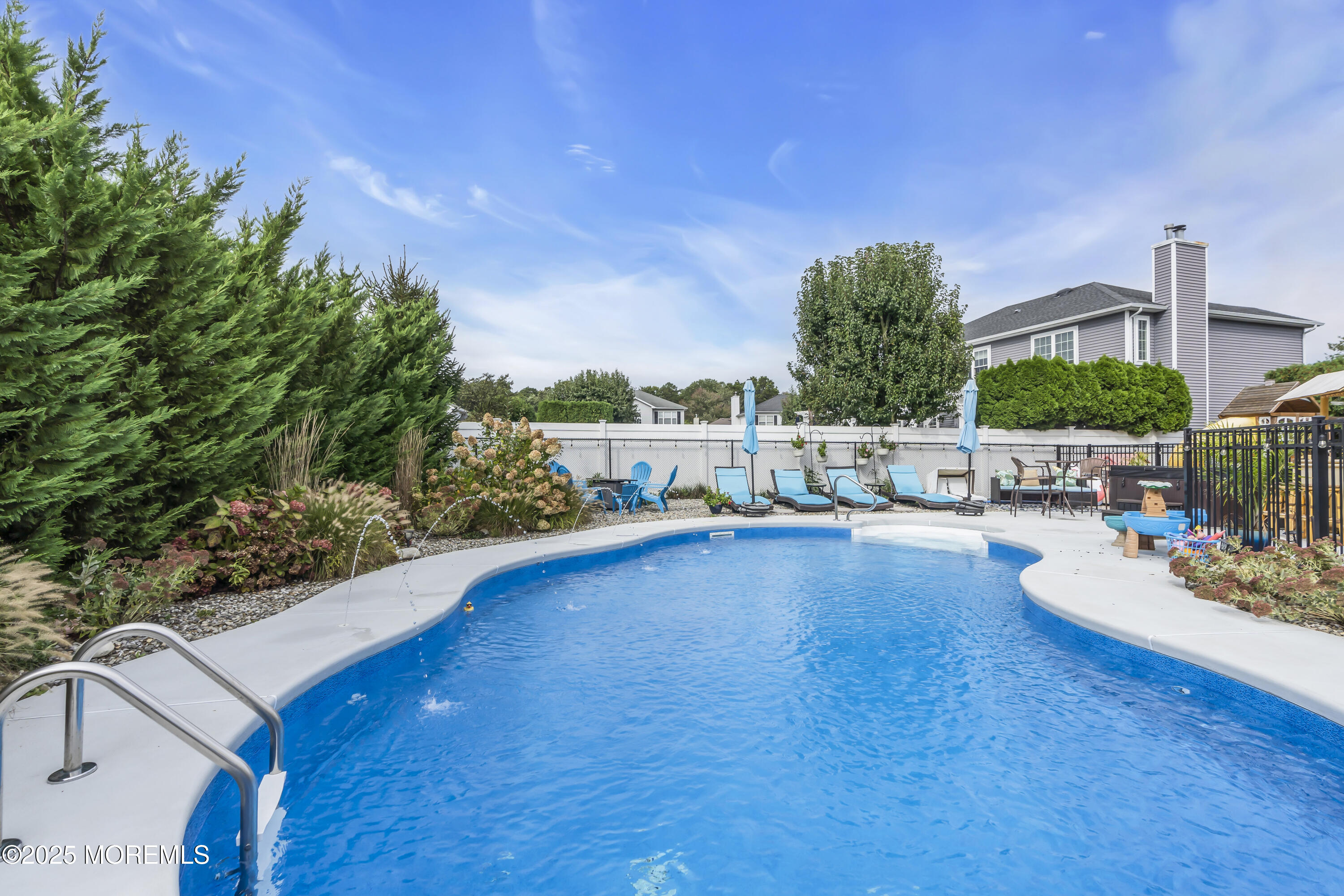 4 Rainbow Drive Howell, NJ 07731 - Photo 3 of 38 a view of a swimming pool with an outdoor seating and a garden