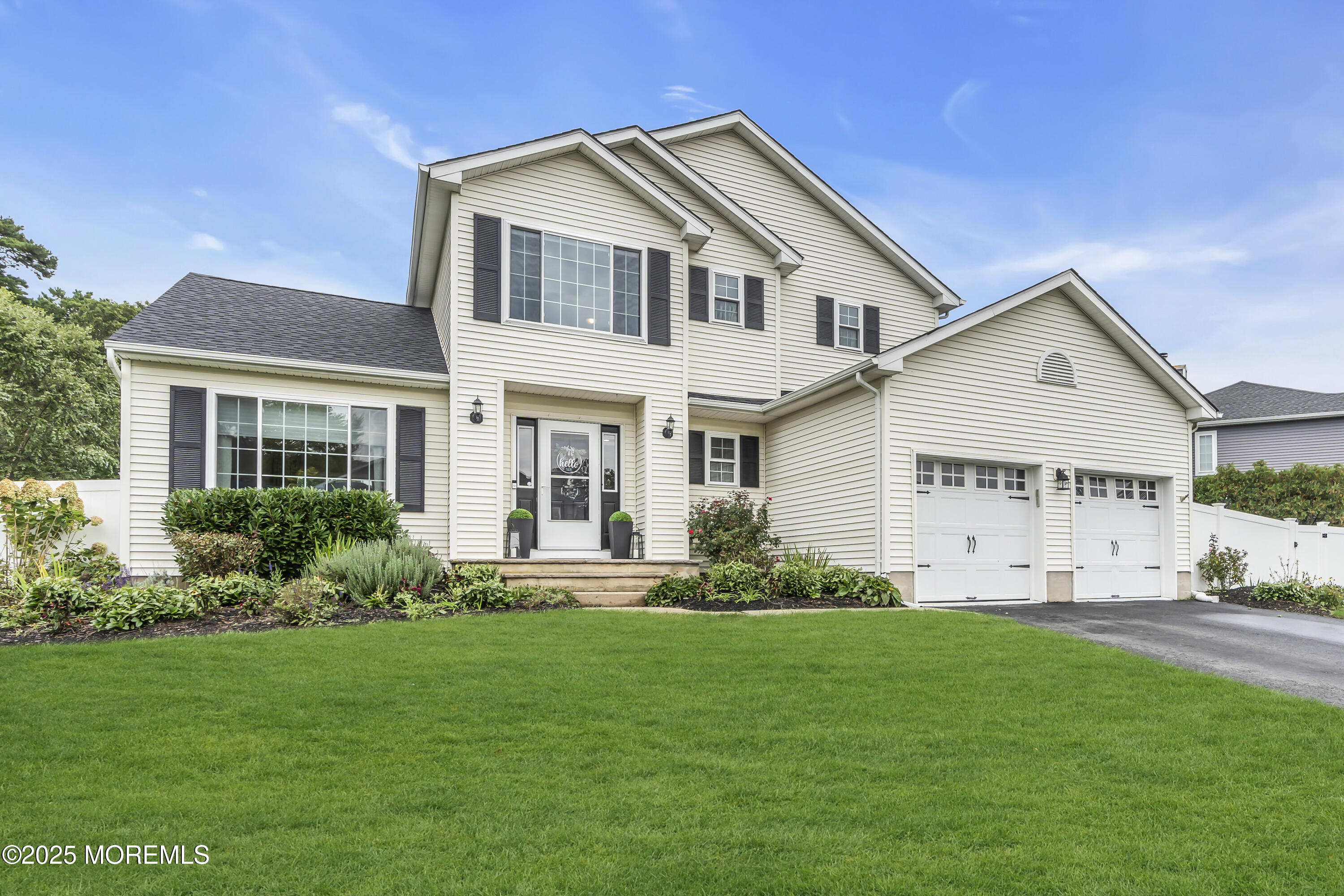 4 Rainbow Drive Howell, NJ 07731 - Photo 4 of 38 a front view of a house with a yard and trees
