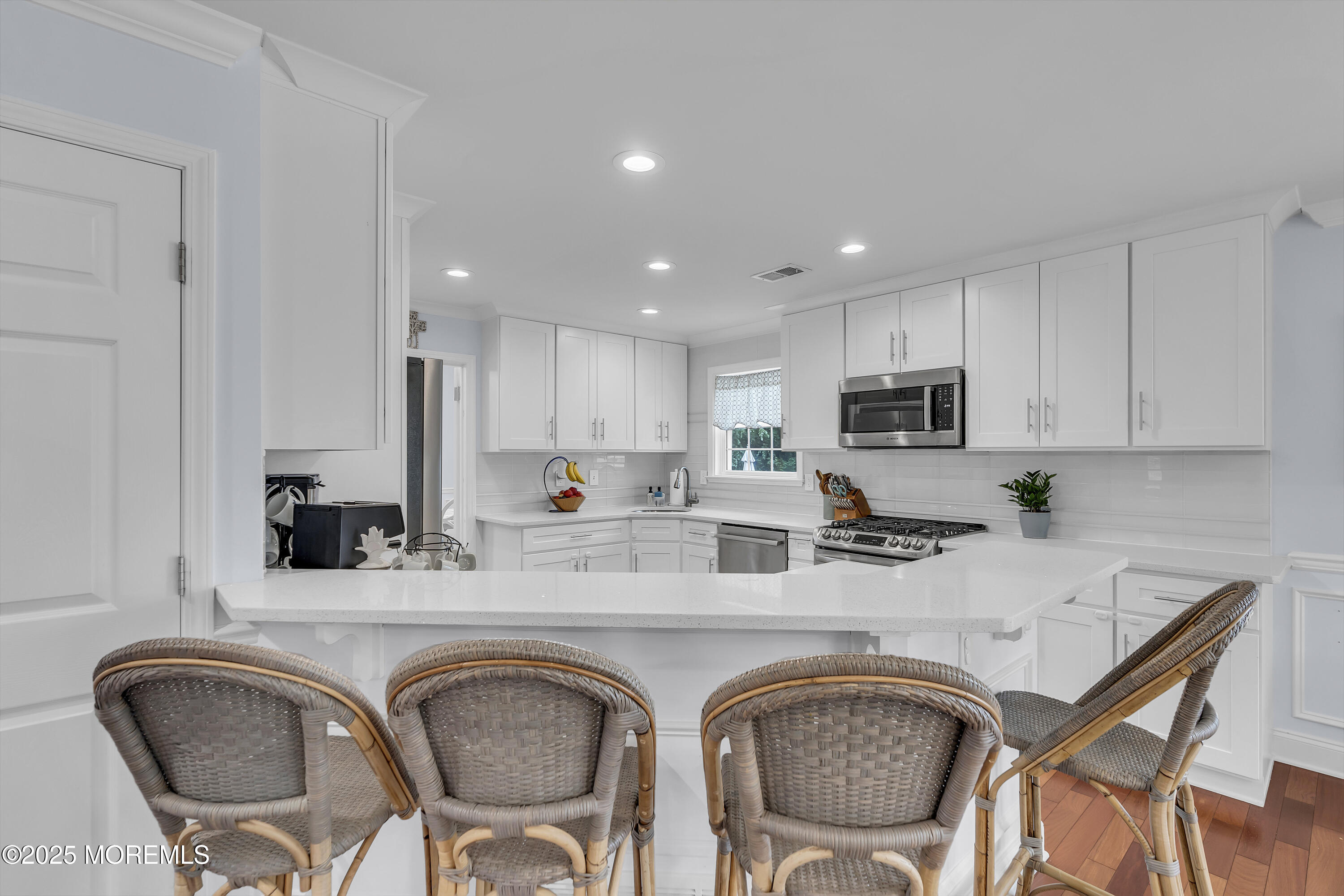 4 Rainbow Drive Howell, NJ 07731 - Photo 9 of 38 a kitchen with stainless steel appliances granite countertop a dining table chairs sink and cabinets