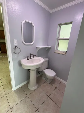 a bathroom with a sink toilet and a mirror