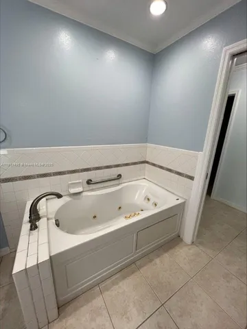 a bathroom with a bathtub and shower