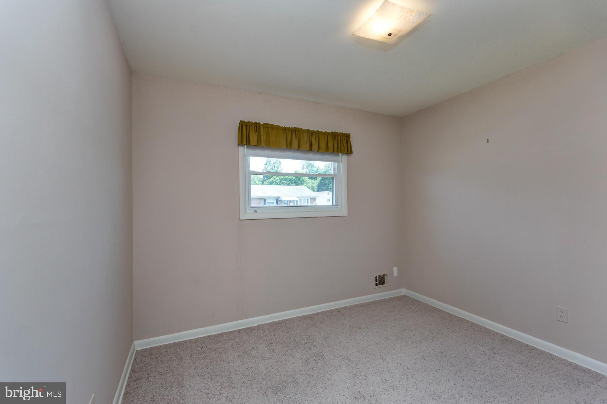 3710 Parkfield Road Baltimore, MD 21244 - Photo 11 of 28 wooden floor in an empty room with a window