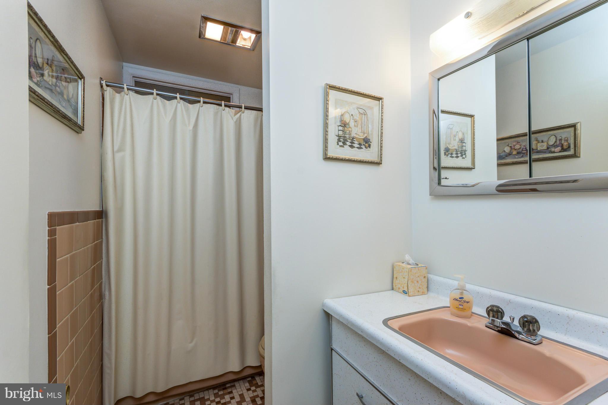 3710 Parkfield Road Baltimore, MD 21244 - Photo 13 of 28 a bathroom with a sink and a mirror