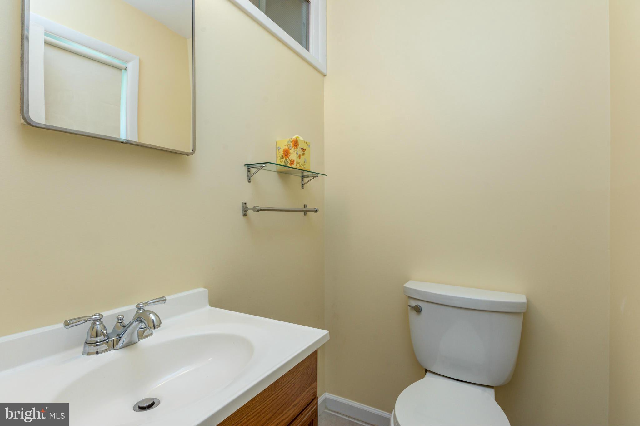 3710 Parkfield Road Baltimore, MD 21244 - Photo 19 of 28 a white toilet sitting next to a bathroom sink