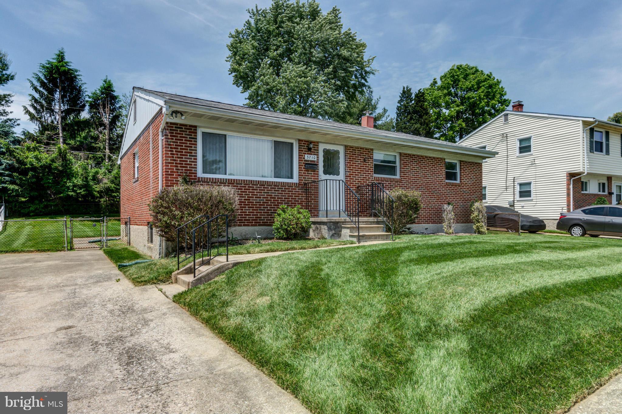 3710 Parkfield Road Baltimore, MD 21244 - Photo 3 of 28 a view of a yard in front of a house with plants and a patio