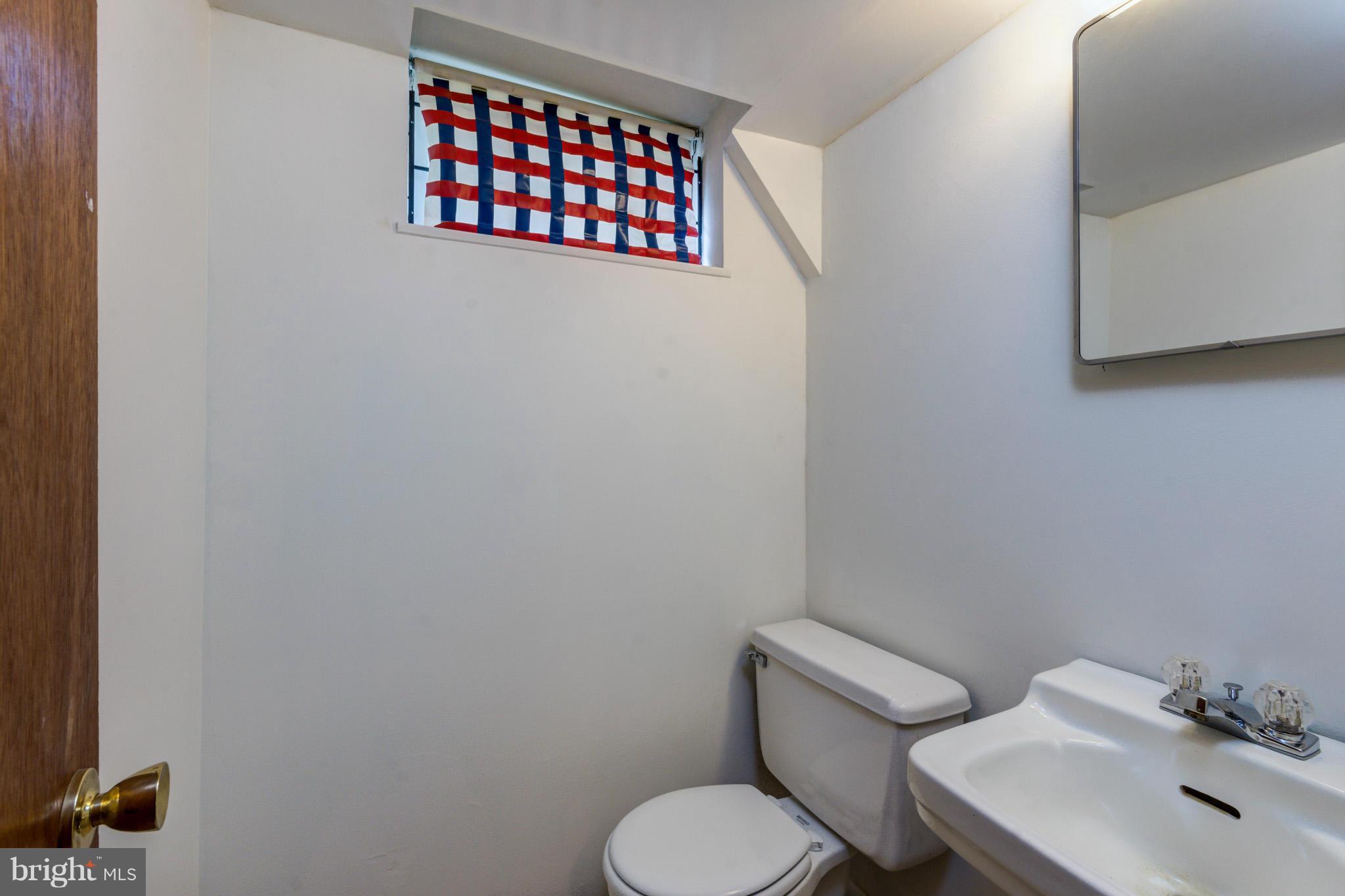 3710 Parkfield Road Baltimore, MD 21244 - Photo 23 of 28 a white toilet sitting next to a bathroom sink
