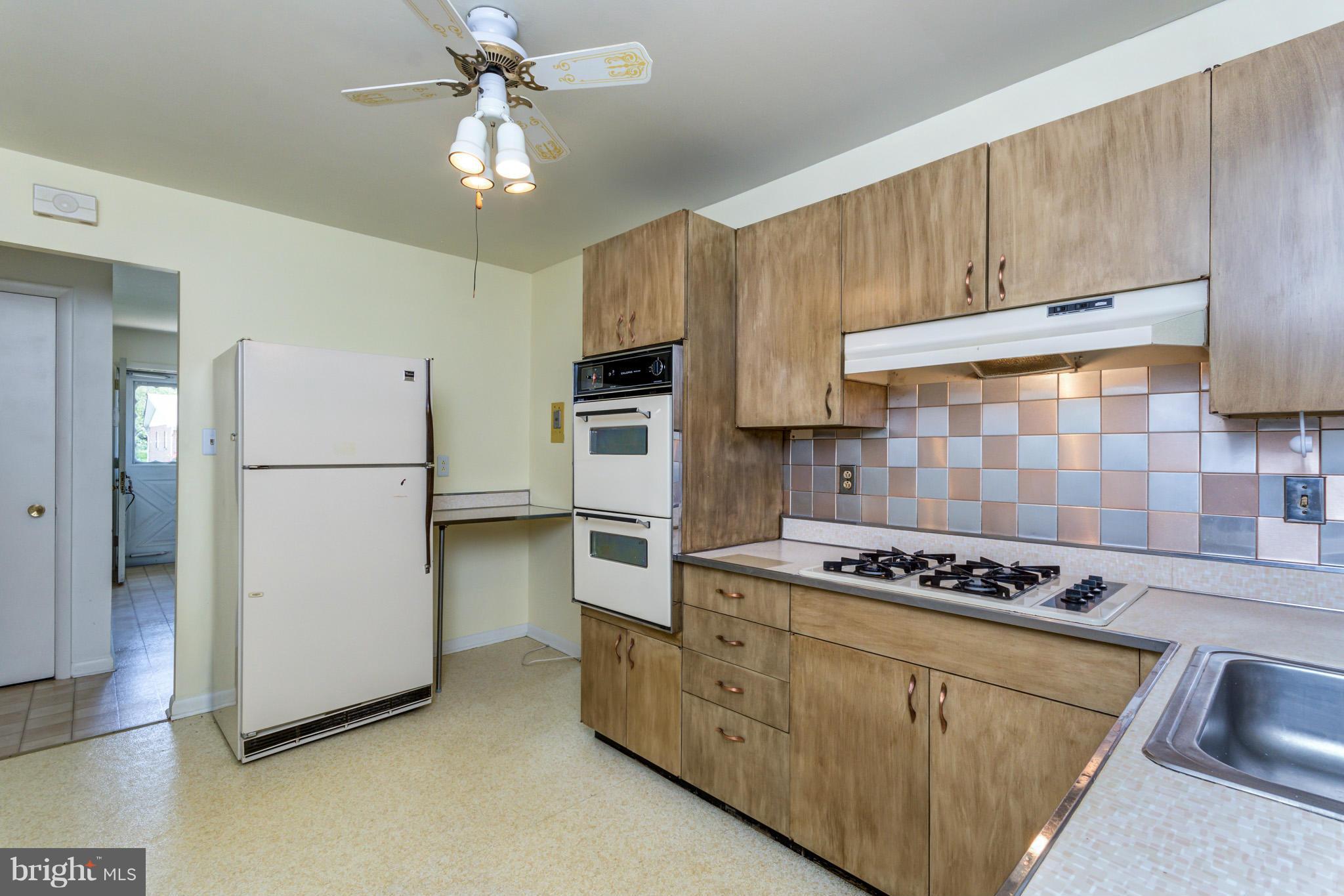 3710 Parkfield Road Baltimore, MD 21244 - Photo 9 of 28 a kitchen with cabinets and steel stainless steel appliances