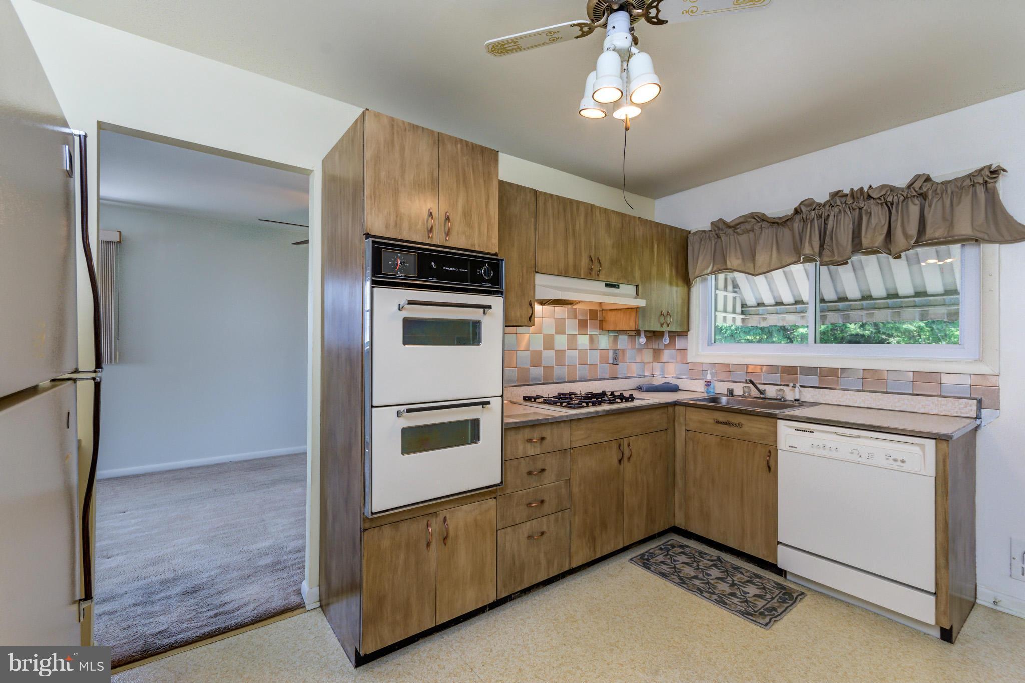 3710 Parkfield Road Baltimore, MD 21244 - Photo 10 of 28 a kitchen with cabinets and window