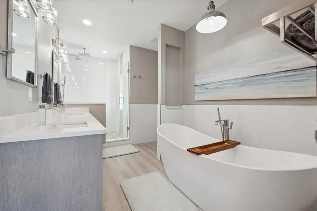 a kitchen with stainless steel appliances kitchen island granite countertop a table chairs microwave and sink