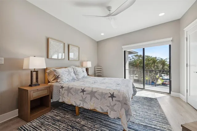 a living room with furniture a flat screen tv and a floor to ceiling window