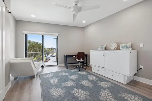 a bedroom with a large bed and a flat tv screen on a dresser