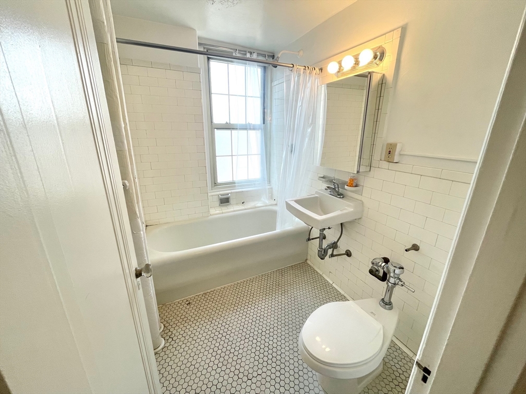 1401 Beacon Street, Unit 704 Brookline, MA 02446 - Photo 11 of 11 a bathroom with a toilet a sink and a bathtub
