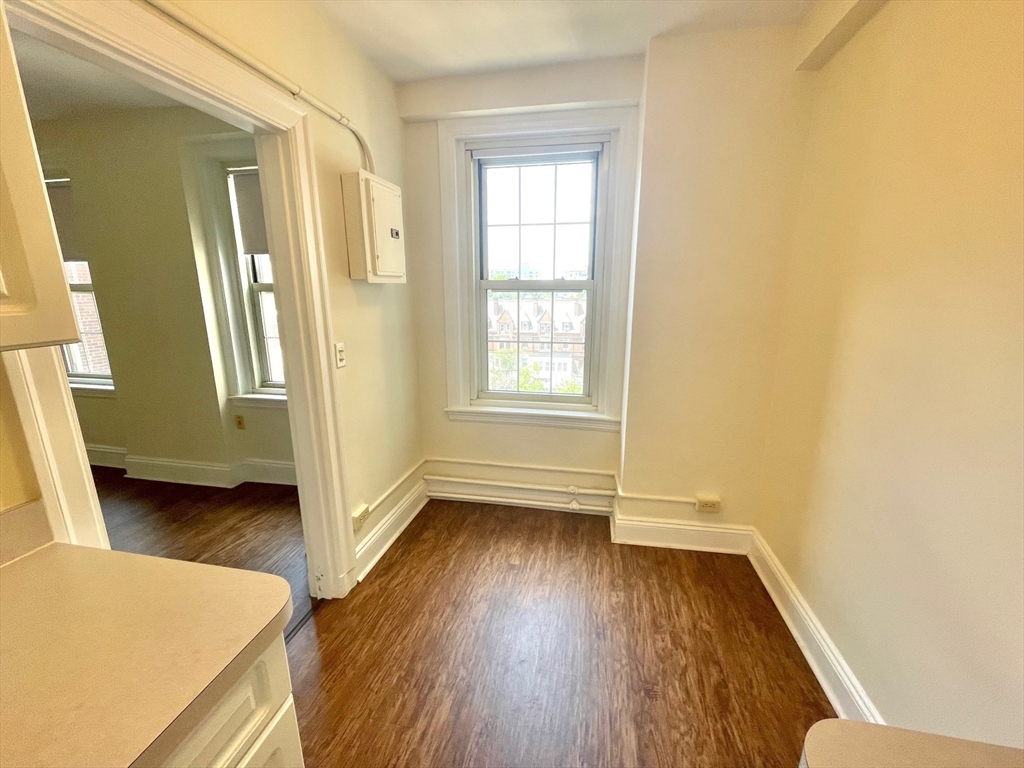 1401 Beacon Street, Unit 704 Brookline, MA 02446 - Photo 9 of 11 wooden floor in an empty room with a window