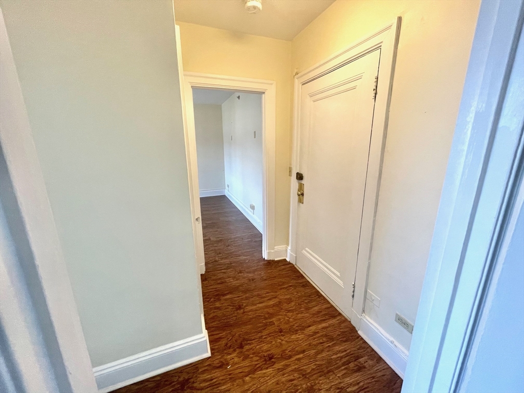 1401 Beacon Street, Unit 704 Brookline, MA 02446 - Photo 10 of 11 a view of a hallway with wooden floor