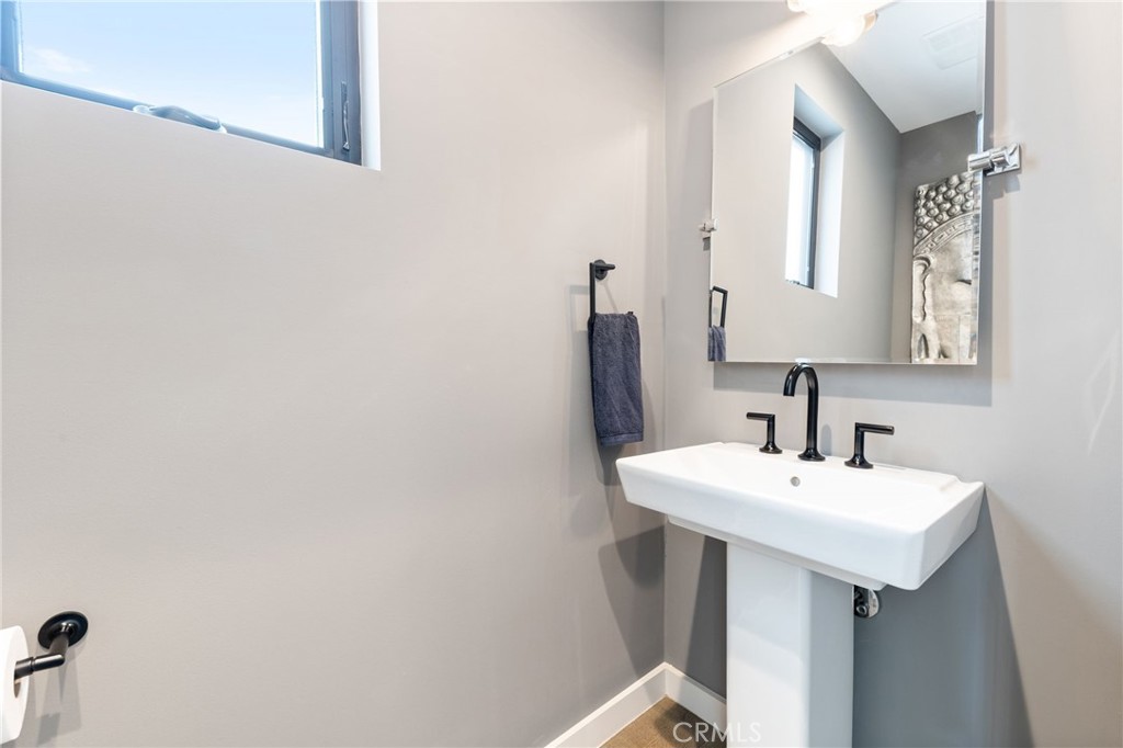 1002 Huntington Street Huntington Beach, CA 92648 - Photo 12 of 43 a bathroom with a sink a mirror and vanity