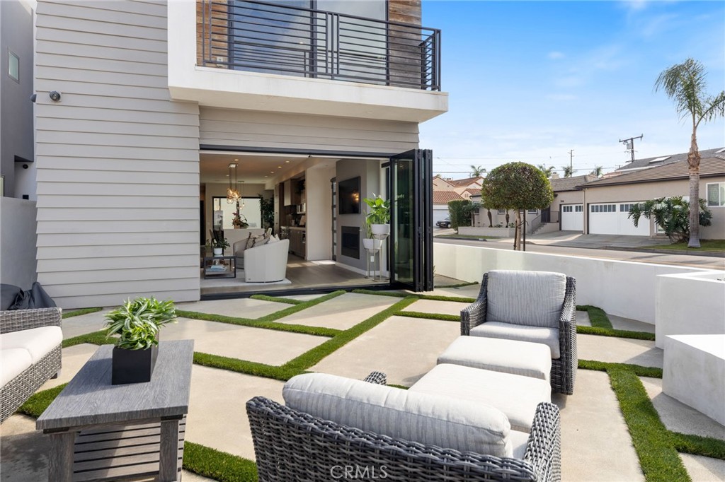 1002 Huntington Street Huntington Beach, CA 92648 - Photo 2 of 43 a view of a patio with couches table and chairs and potted plants