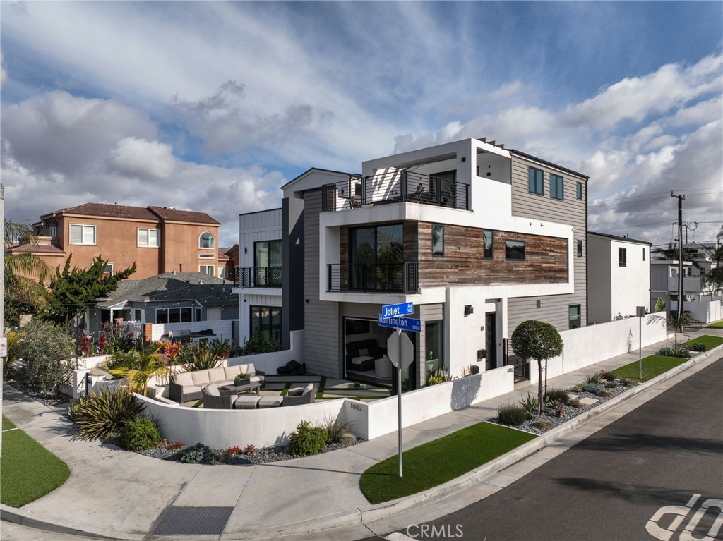 1002 Huntington Street Huntington Beach, CA 92648 - Photo 35 of 43 a front view of a building with sitting area and garden
