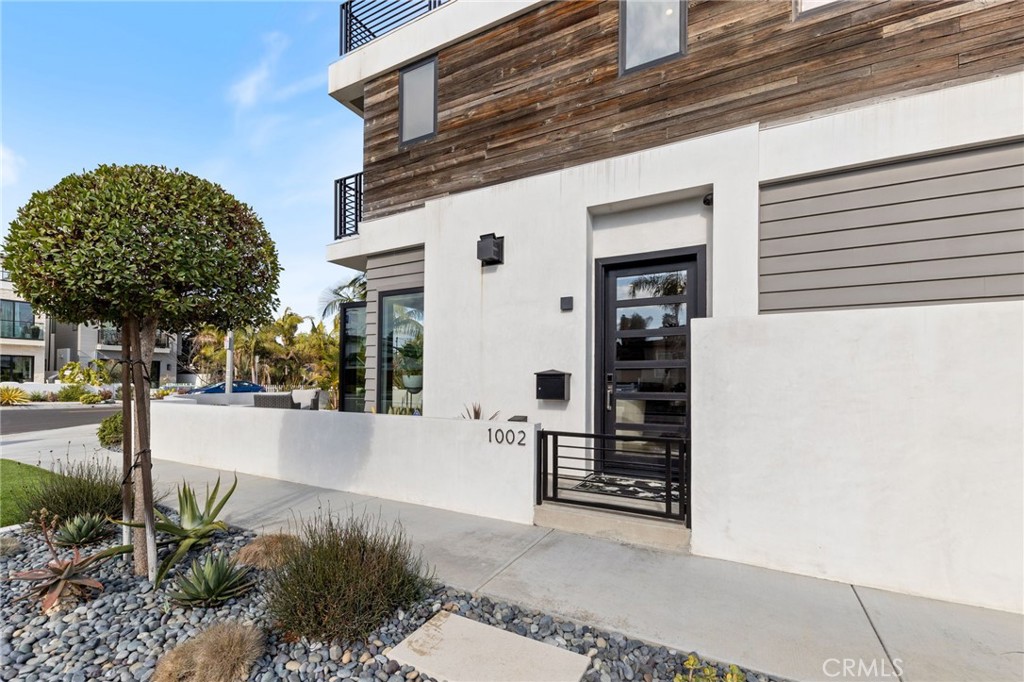 1002 Huntington Street Huntington Beach, CA 92648 - Photo 37 of 43 a view of a house with a small yard and potted plants