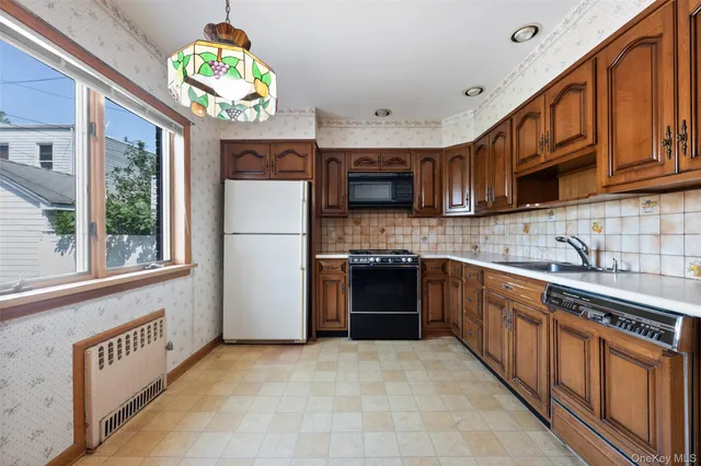 a kitchen with stainless steel appliances granite countertop a refrigerator a stove top oven a sink and dishwasher