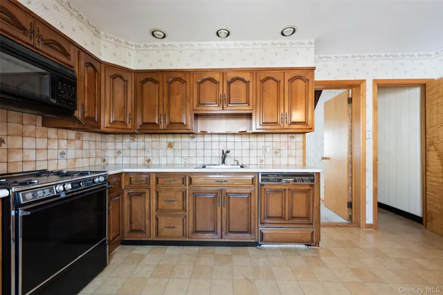 a kitchen with stainless steel appliances granite countertop a stove and a microwave