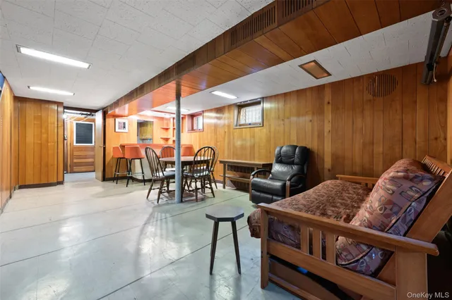 a living room with furniture and large windows