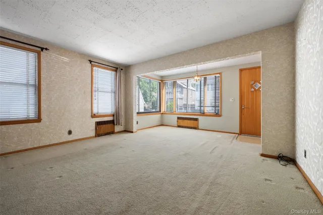 an empty room with an empty space and windows