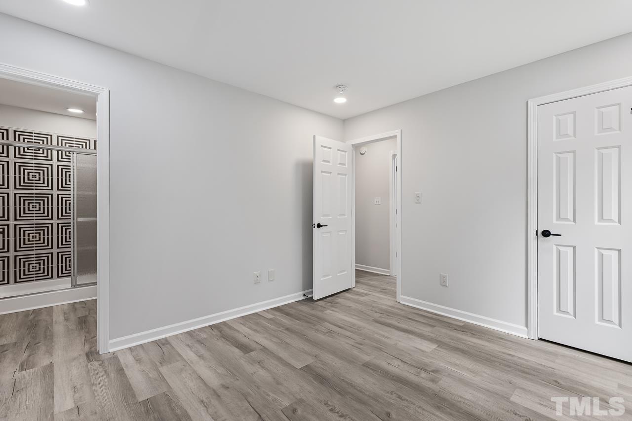 704 Hartford Road Raleigh, NC 27610 - Photo 16 of 29 a view of an empty room with wooden floor and a window