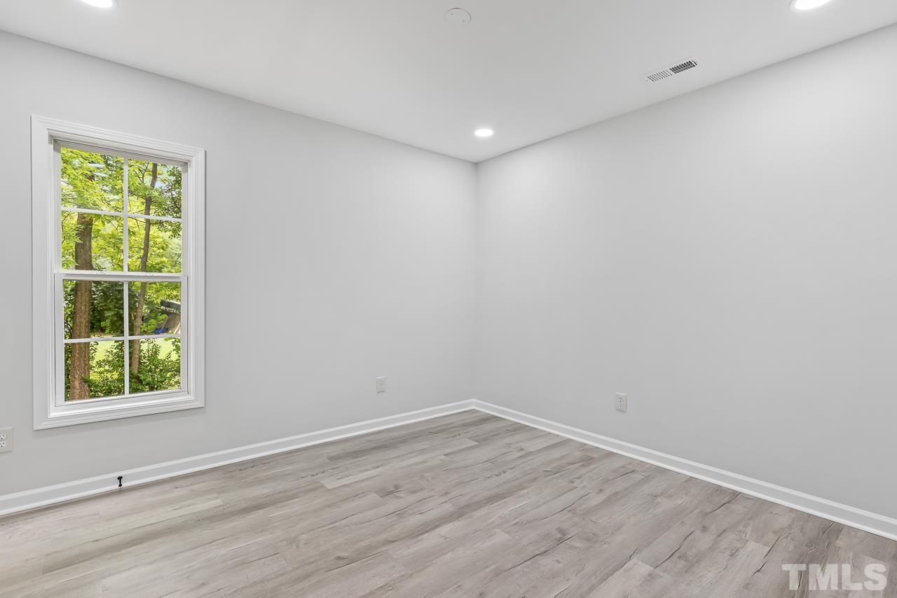 704 Hartford Road Raleigh, NC 27610 - Photo 20 of 29 wooden floor in an empty room with a window