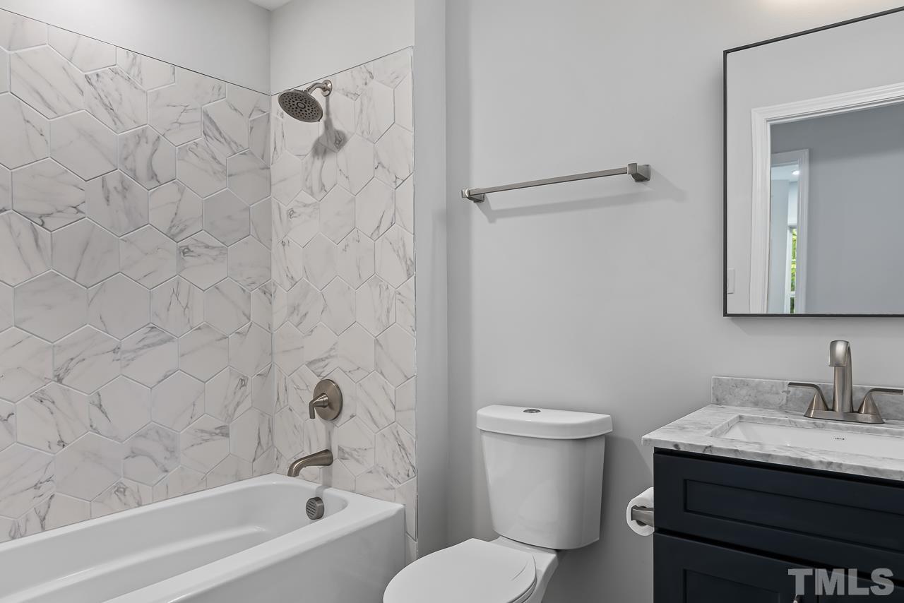 704 Hartford Road Raleigh, NC 27610 - Photo 22 of 29 a bathroom with a granite countertop sink toilet and shower