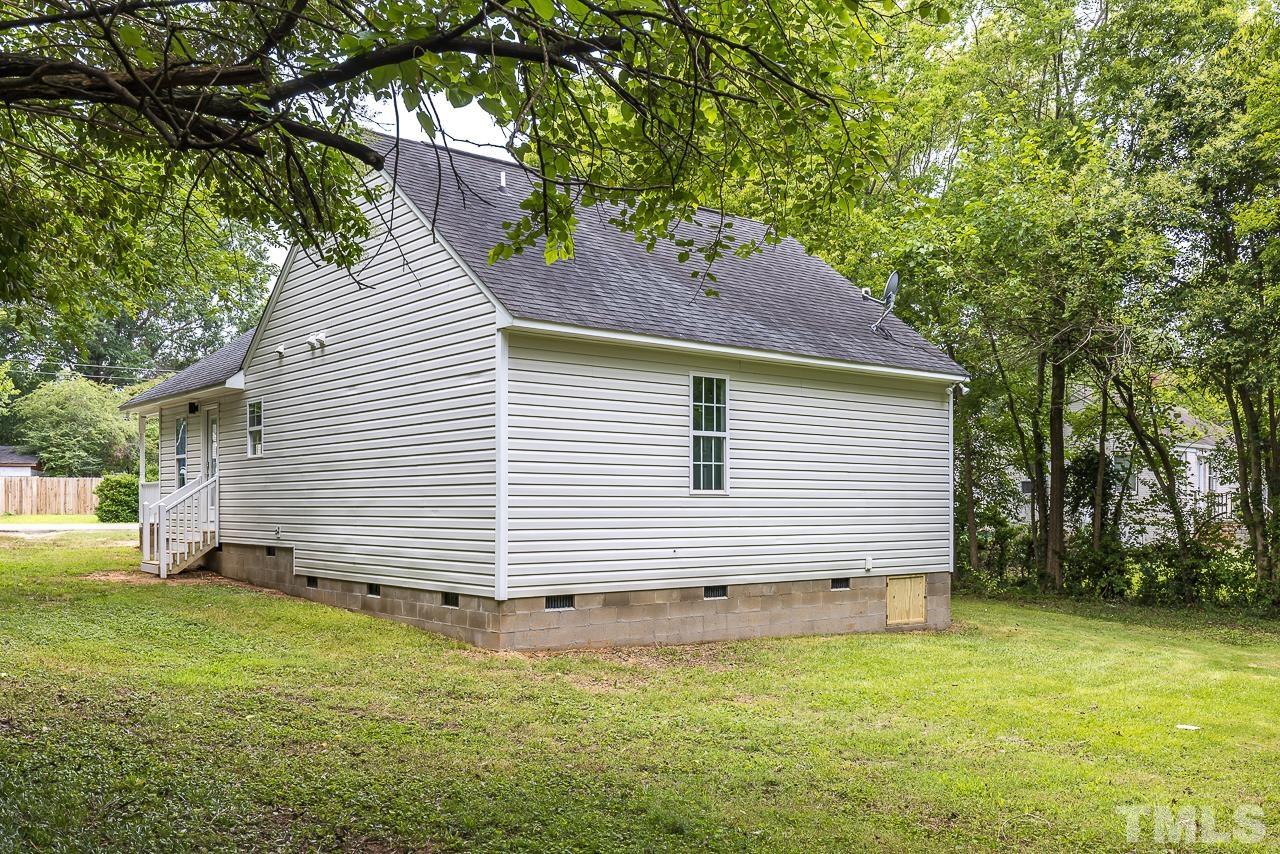 704 Hartford Road Raleigh, NC 27610 - Photo 24 of 29 a backyard of a house with table and chairs
