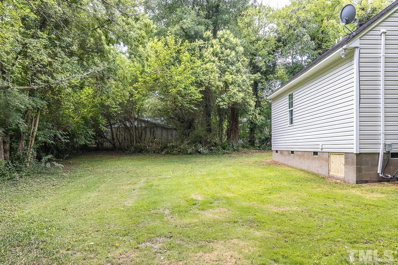704 Hartford Road Raleigh, NC 27610 - Photo 27 of 29 a view of a backyard with a garden