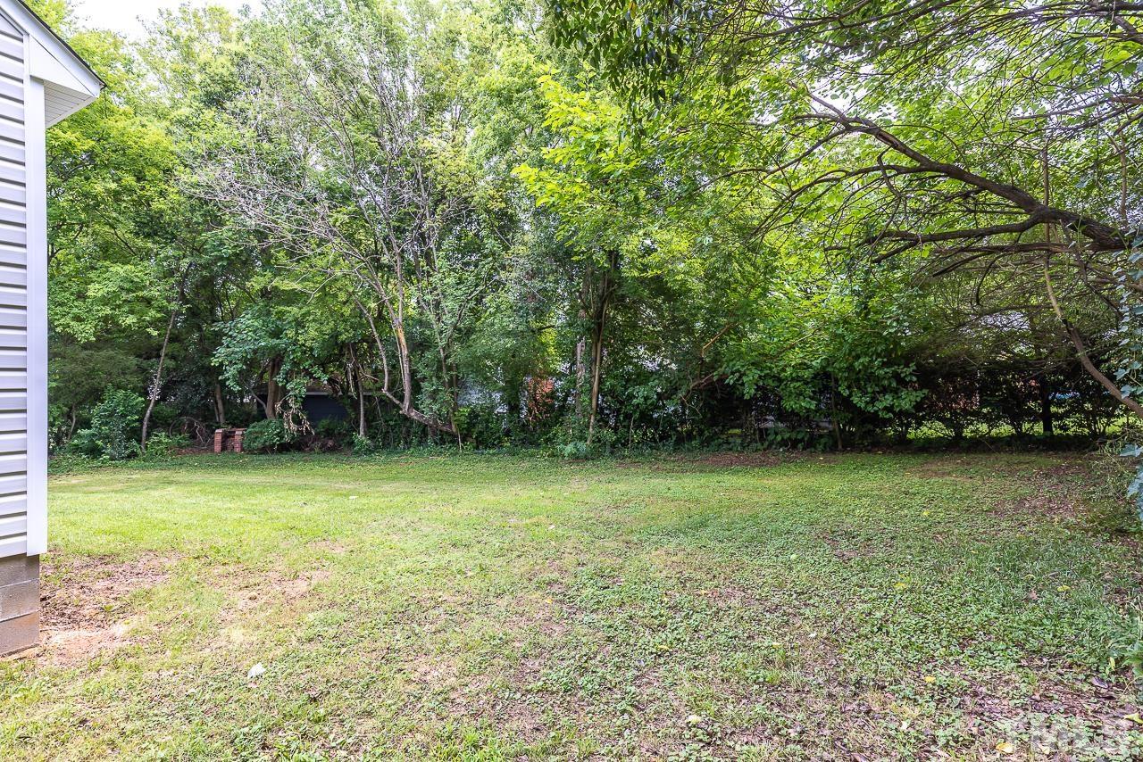 704 Hartford Road Raleigh, NC 27610 - Photo 29 of 29 a view of a field with trees in the background