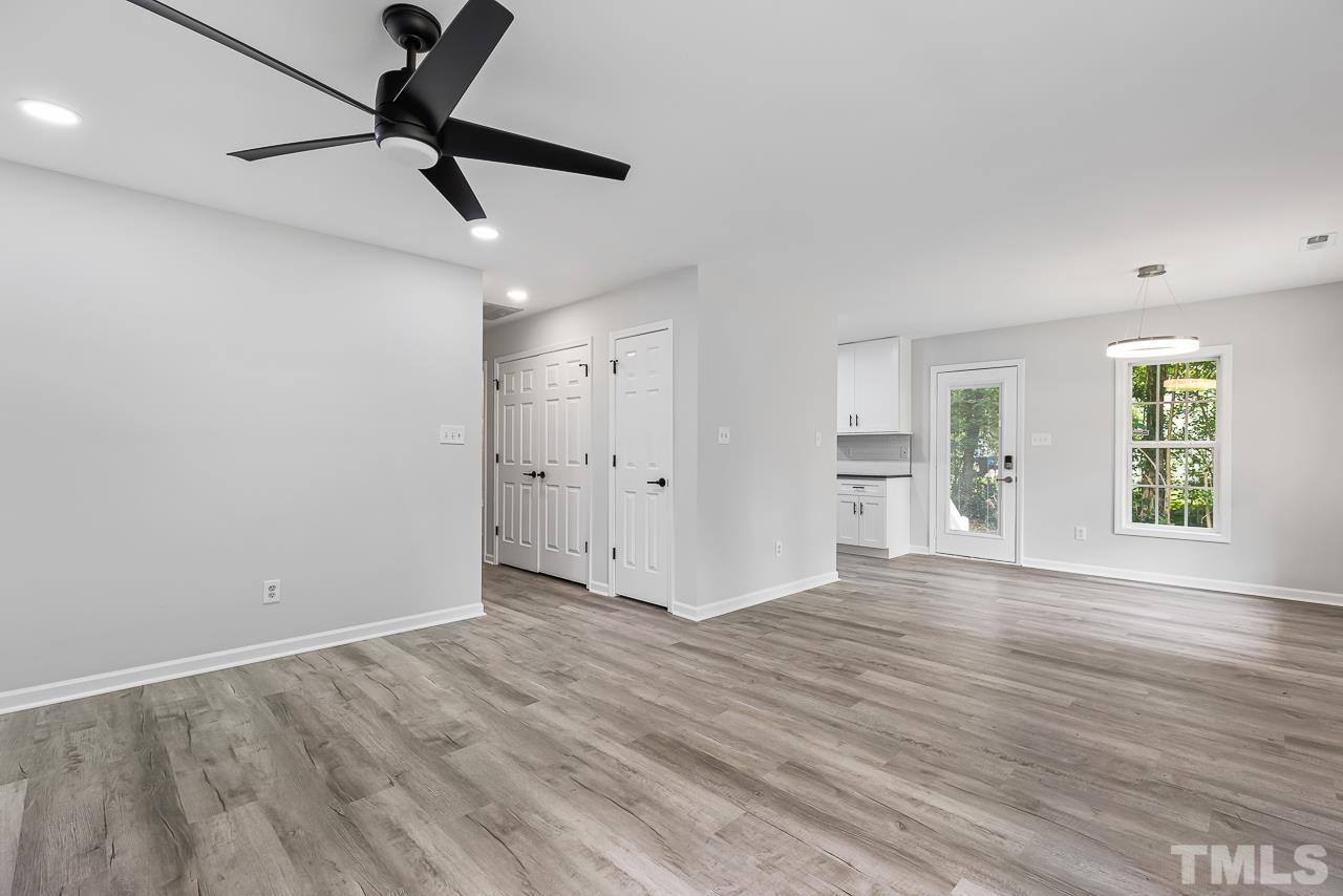 704 Hartford Road Raleigh, NC 27610 - Photo 6 of 29 wooden floor in an empty room with a window