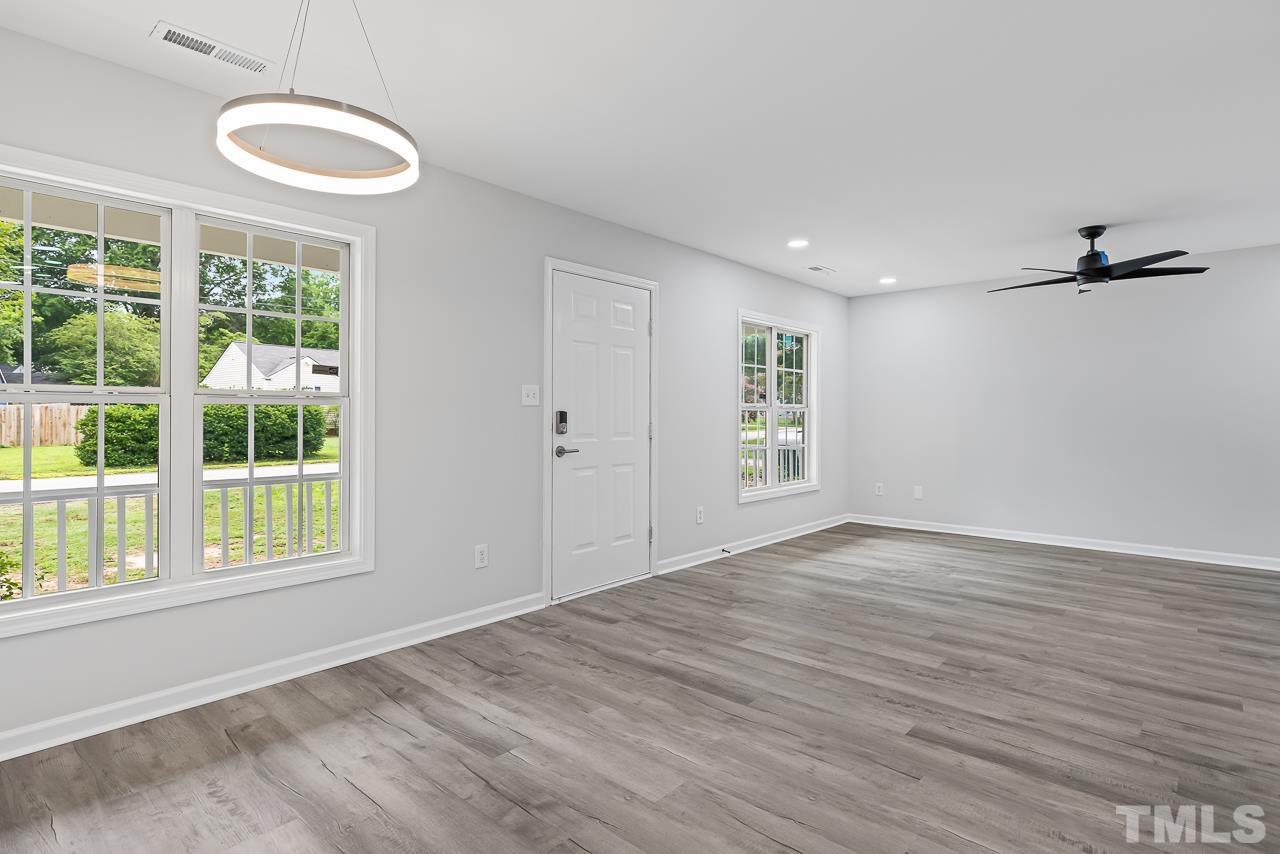 704 Hartford Road Raleigh, NC 27610 - Photo 9 of 29 a view of empty room with wooden floor and fan