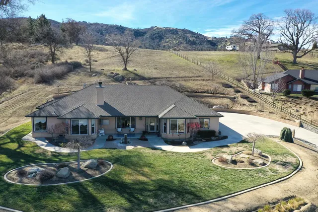 an aerial view of a house with garden patio and mountain view