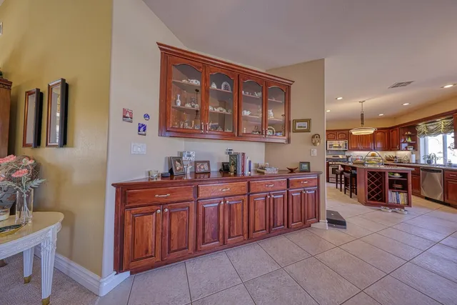 a large kitchen with stainless steel appliances granite countertop a large counter top and a sink