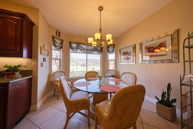 a dining room with furniture and chandelier kitchen view