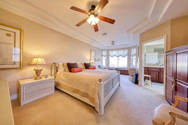 a bed room with a bed and a ceiling fan