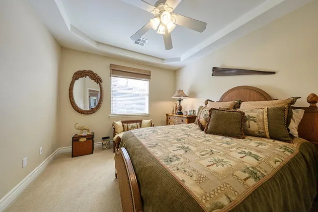 a bedroom with a bed a closet and a chandelier