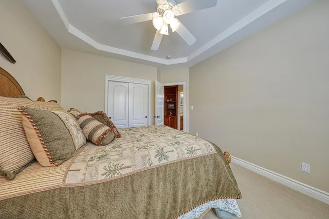 a bedroom with a bed and a ceiling fan