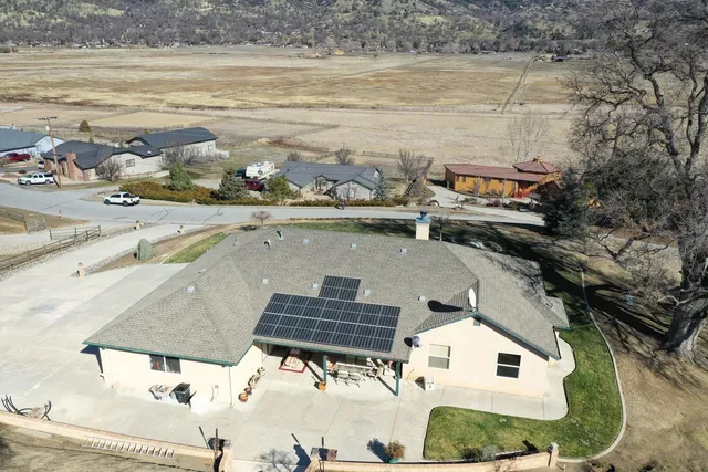 an aerial view of a house with a yard