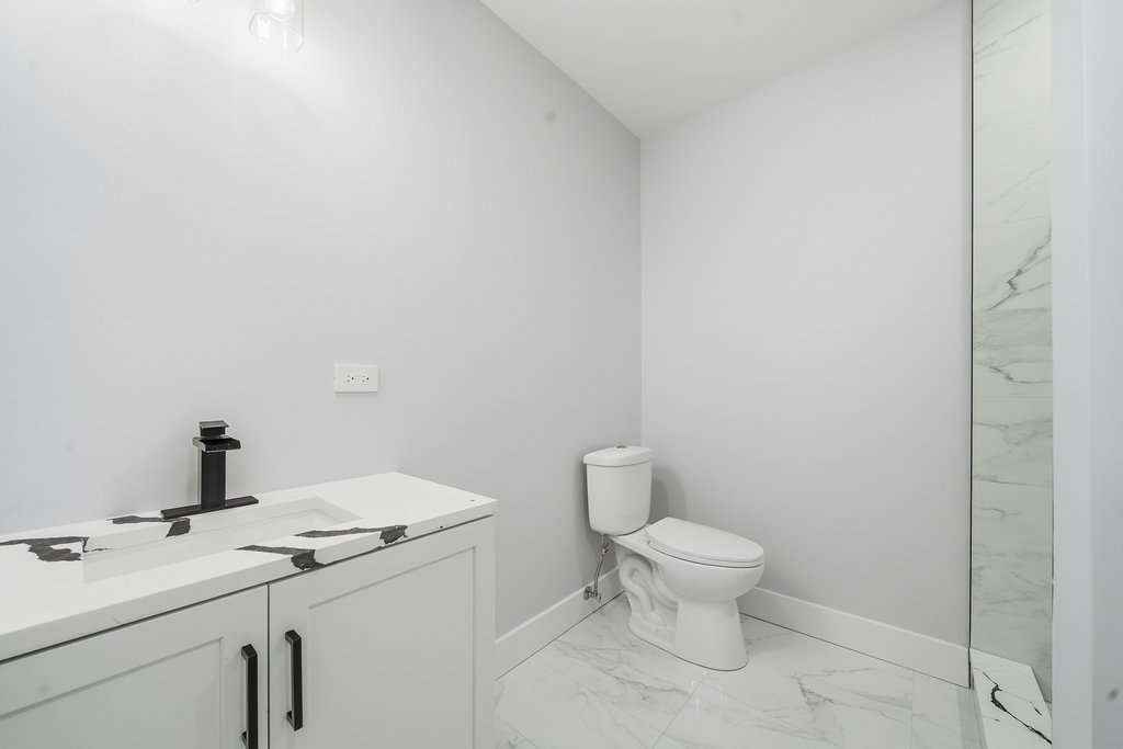 2112 Market Street Blue Island, IL 60406 - Photo 16 of 55 a bathroom with a granite countertop toilet and a sink