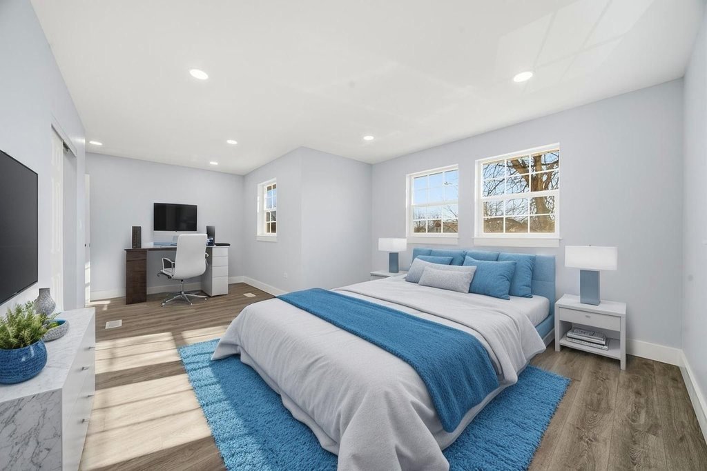 2112 Market Street Blue Island, IL 60406 - Photo 22 of 55 a spacious bedroom with a large bed a flat tv screen and a potted plant