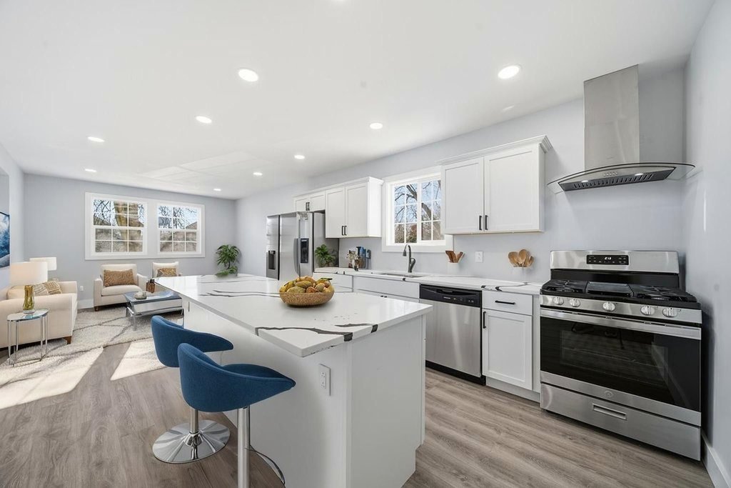 2112 Market Street Blue Island, IL 60406 - Photo 4 of 55 a kitchen with stainless steel appliances kitchen island granite countertop a stove a sink a refrigerator and white cabinets with wooden floor