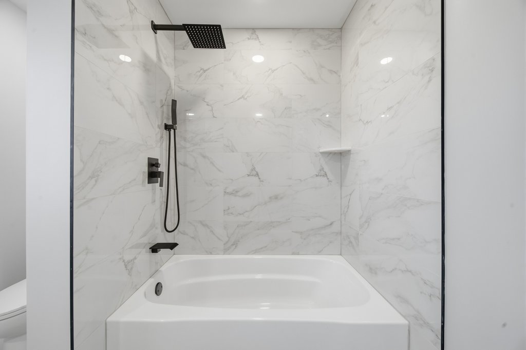 2112 Market Street Blue Island, IL 60406 - Photo 42 of 55 a white bath tub sitting next to a white sink and vanity